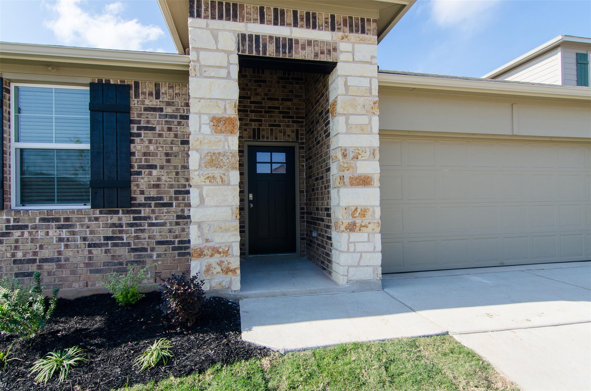 An inviting stone and brick entryway welcomes gue