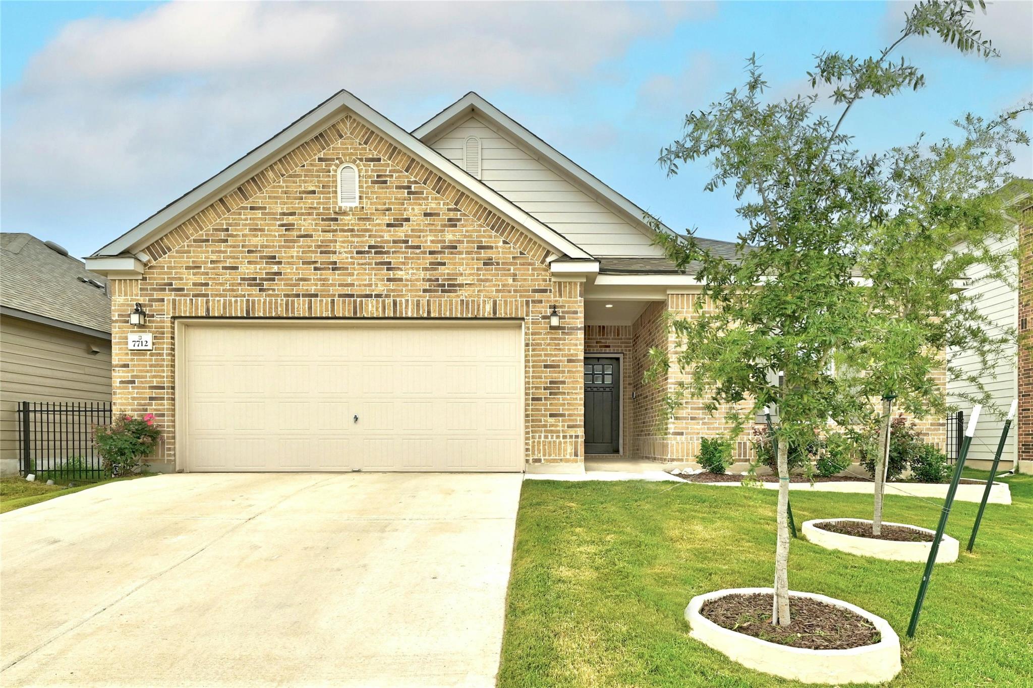 A classic brick exterior and a concrete driveway 