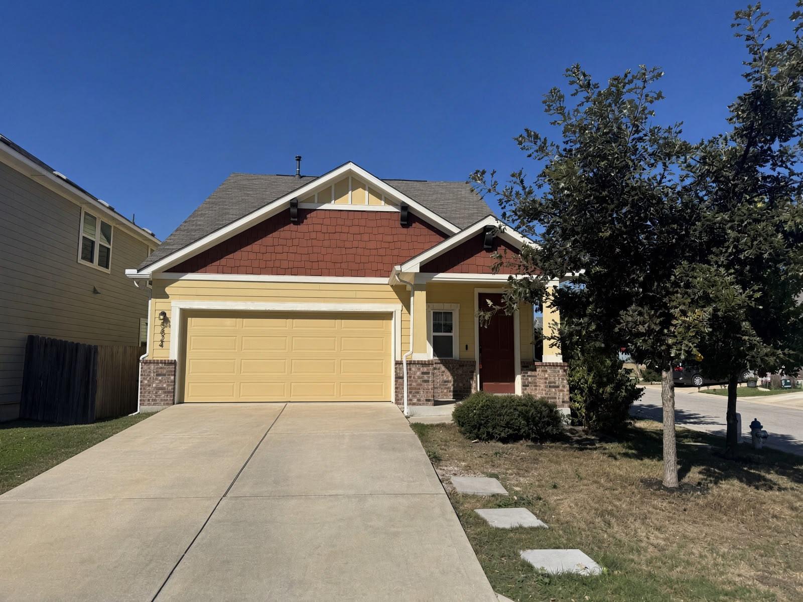 A classic concrete driveway leads to an attached 