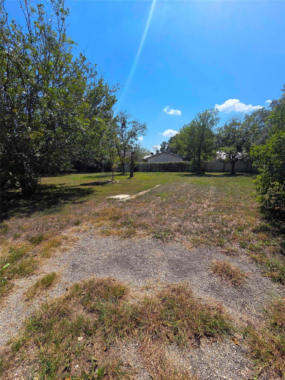 Mature trees frame a grassy lawn offering plenty 