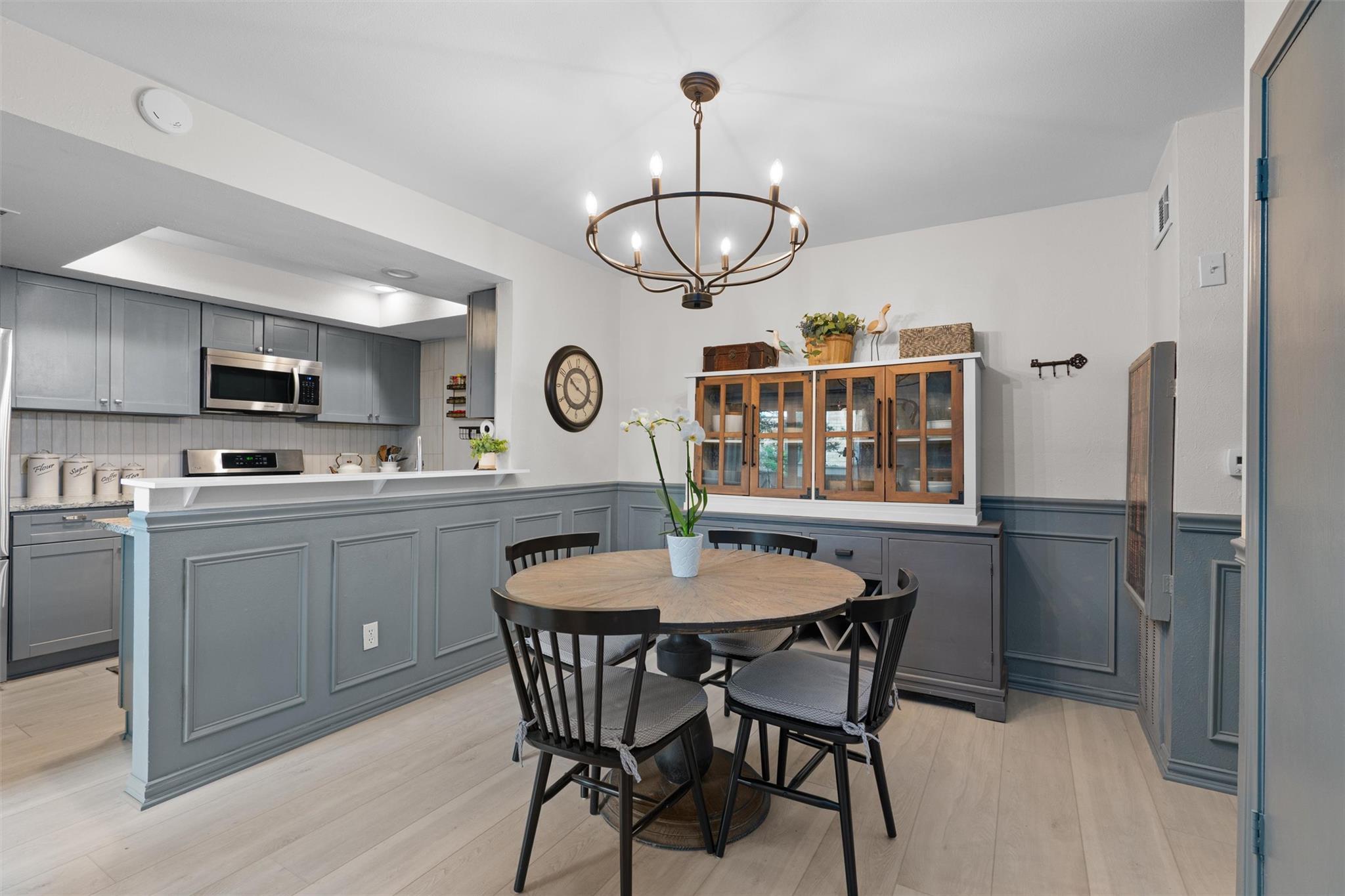 Elegant wainscoting and smooth wood flooring crea