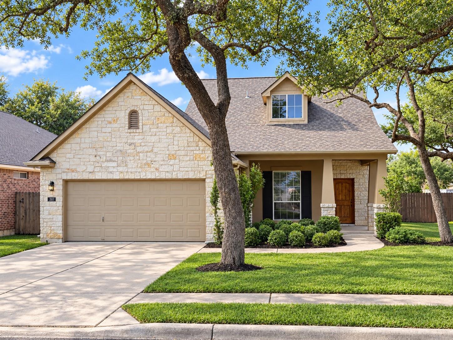 A charming stone and stucco exterior sits nestled