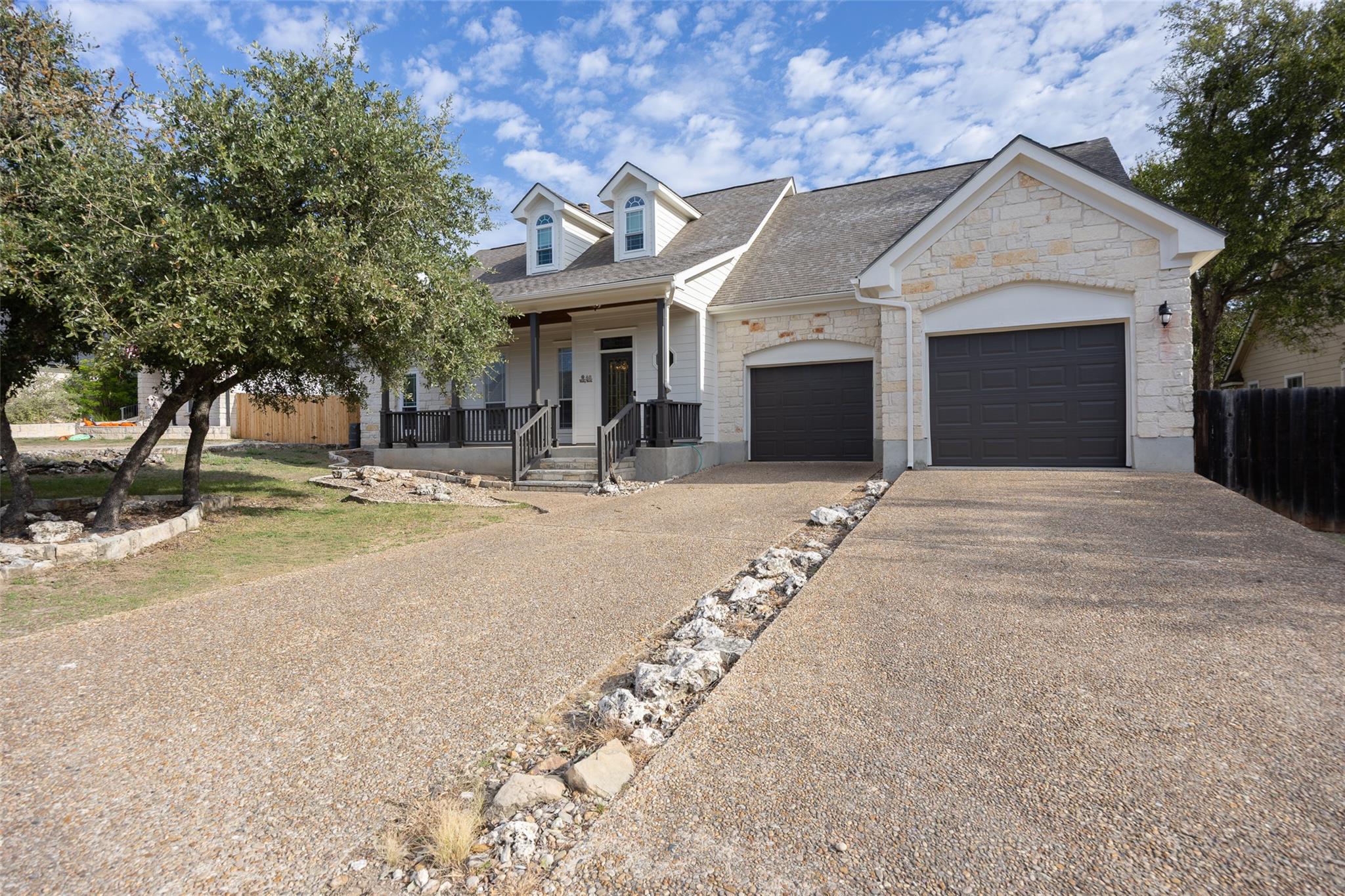 Limestone and wood siding complement this traditi