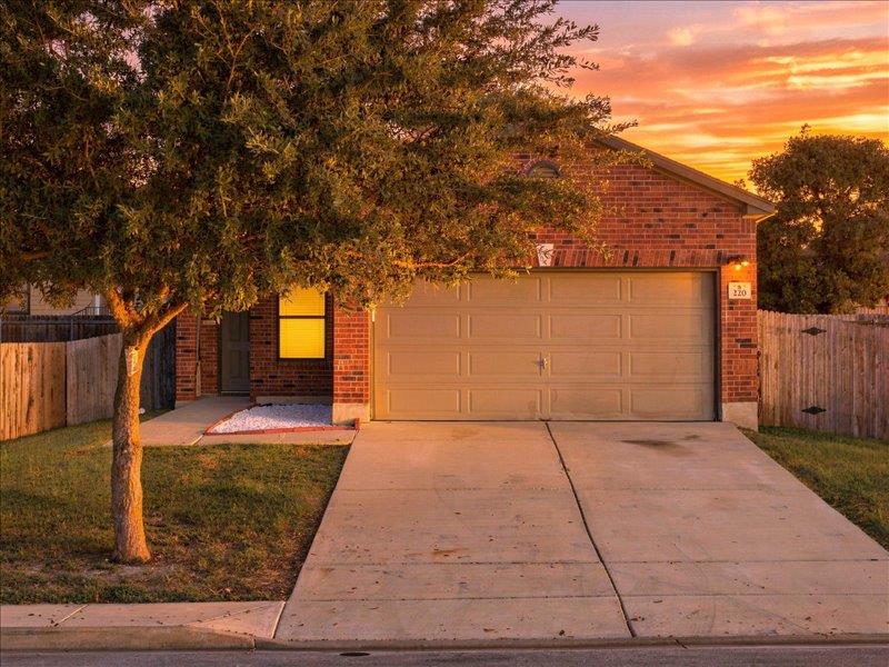 A classic brick exterior and a concrete driveway 