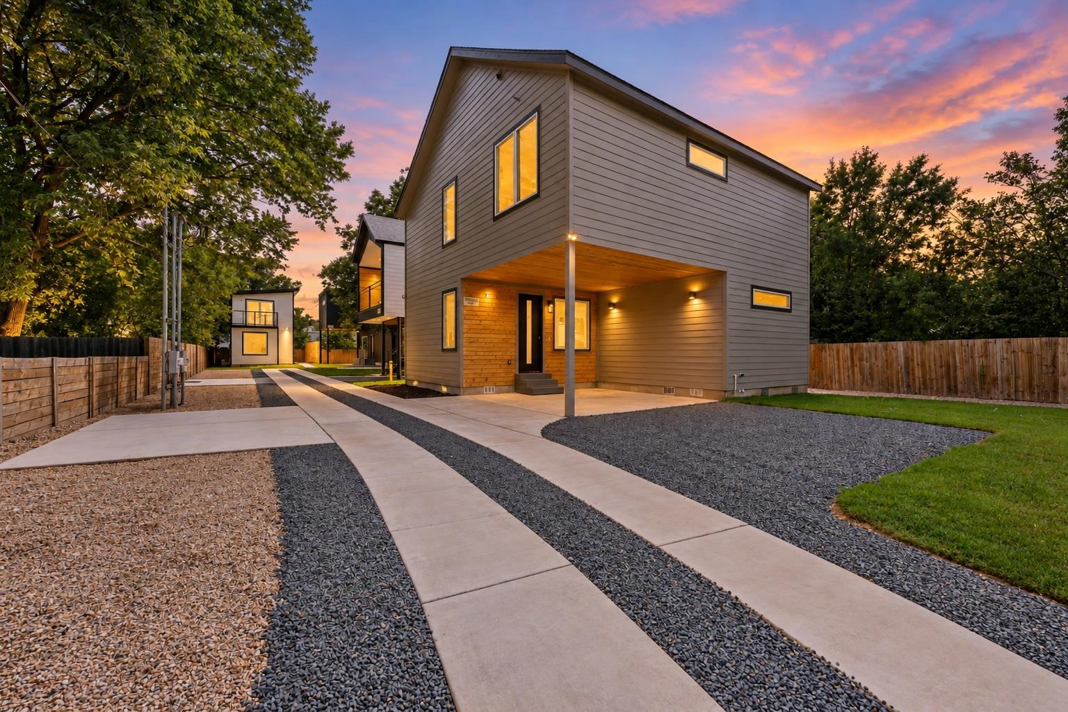 A long concrete driveway leads to this modern two