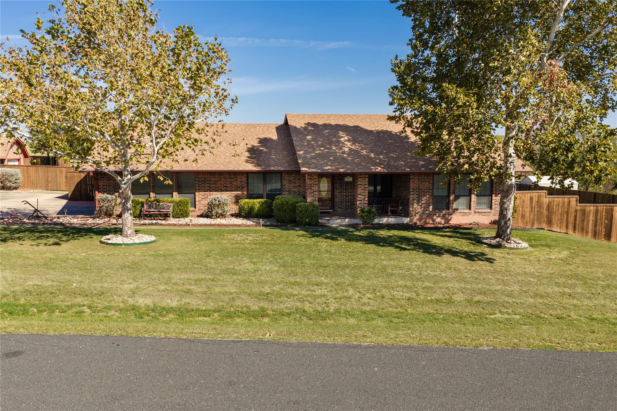 An inviting classic brick elevation rises behind 