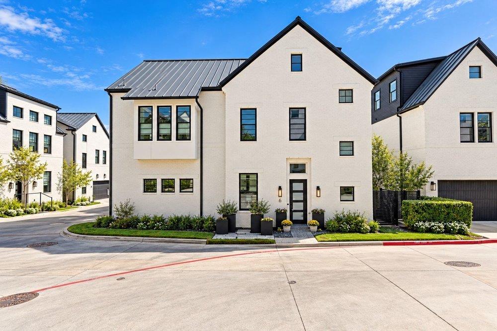 Crisp white brickwork and a modern metal roof cre
