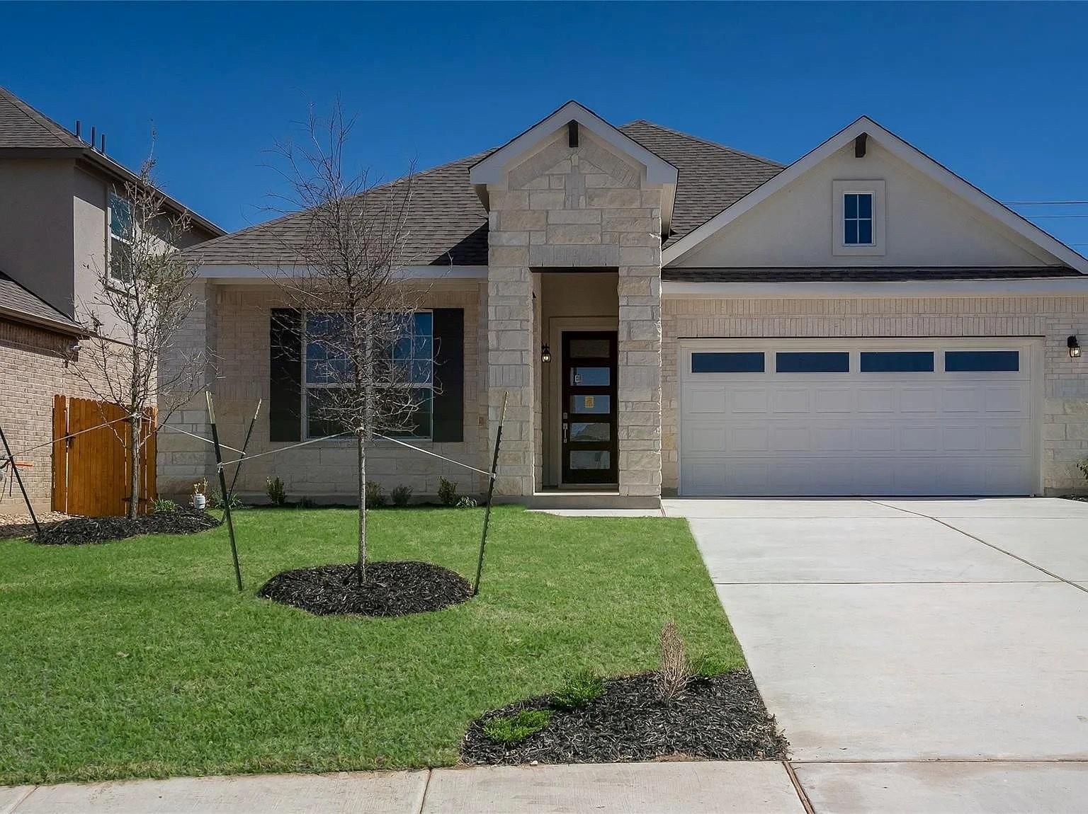 View of front of house featuring stone siding, a 