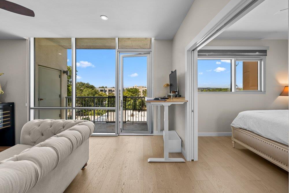 Floor-to-ceiling glass doors open to a private ba