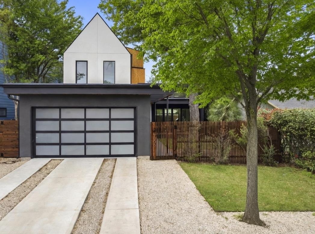 Contemporary home with stucco siding, concrete dr