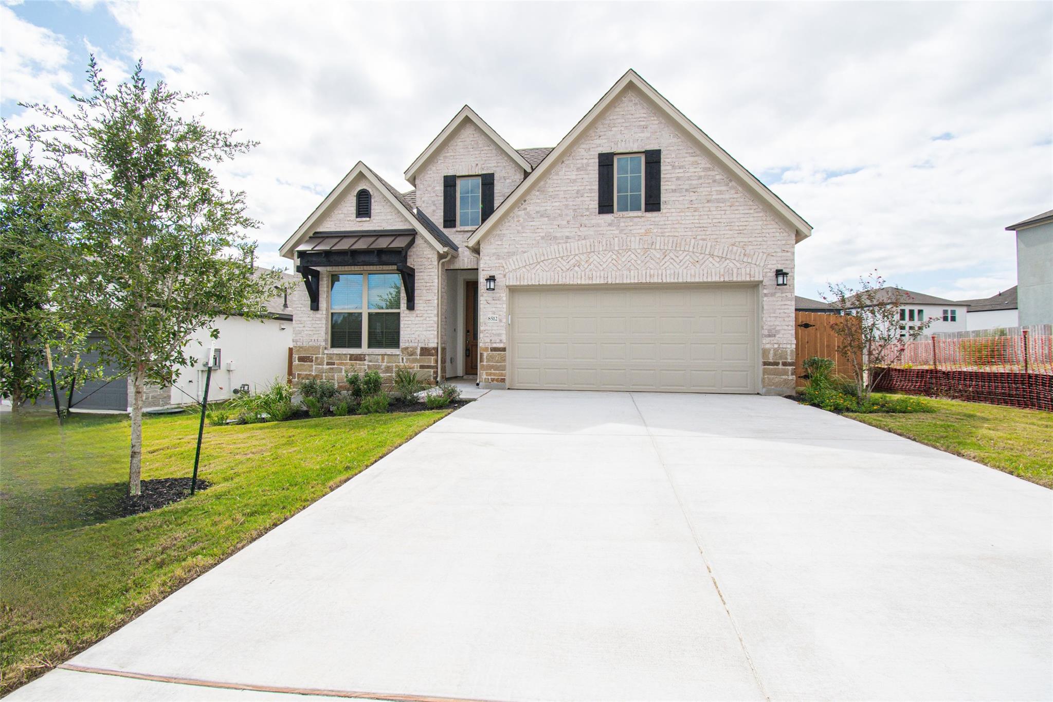 An expansive concrete driveway leads directly to 