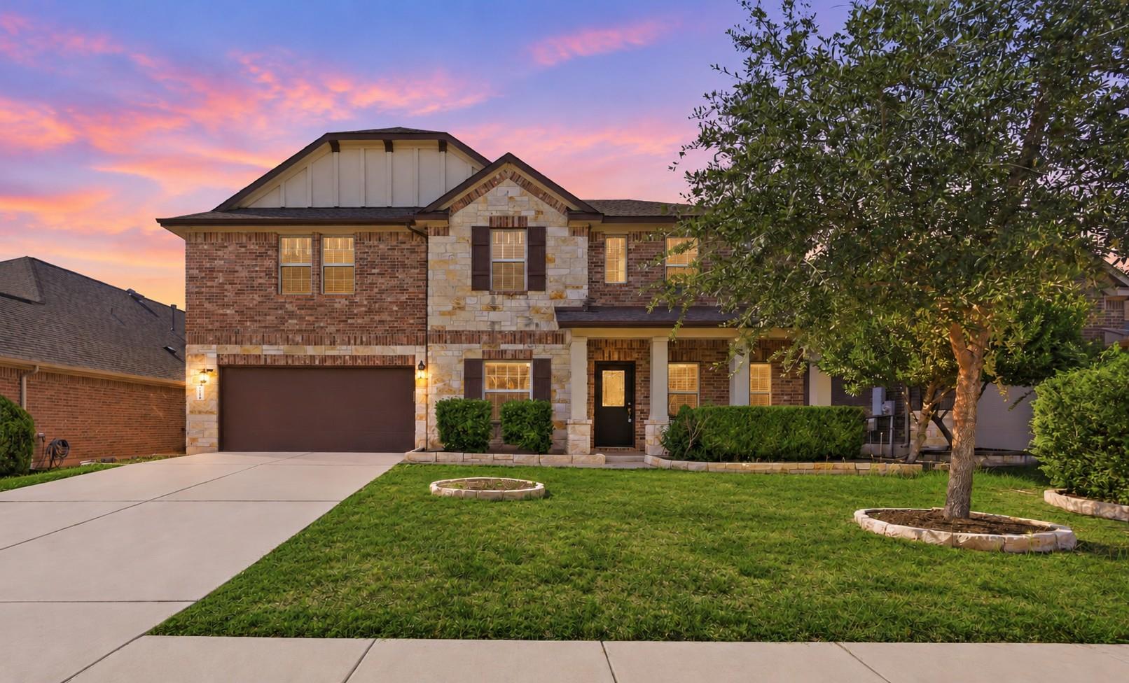An inviting exterior displays brick and stone acc