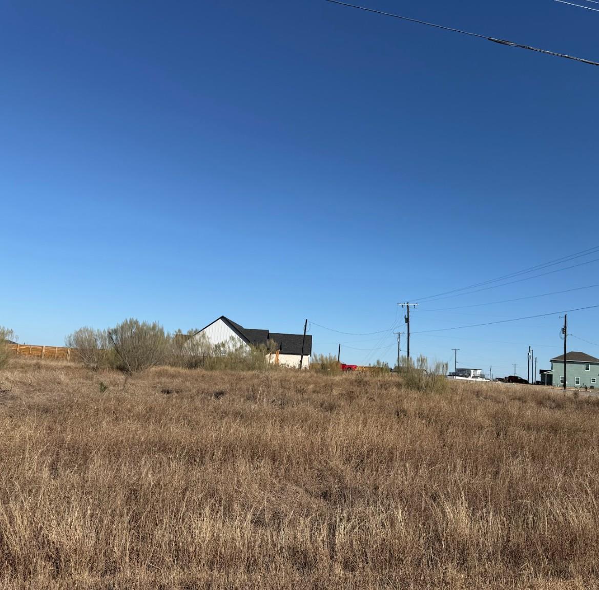 A spacious unimproved building lot sits under cle
