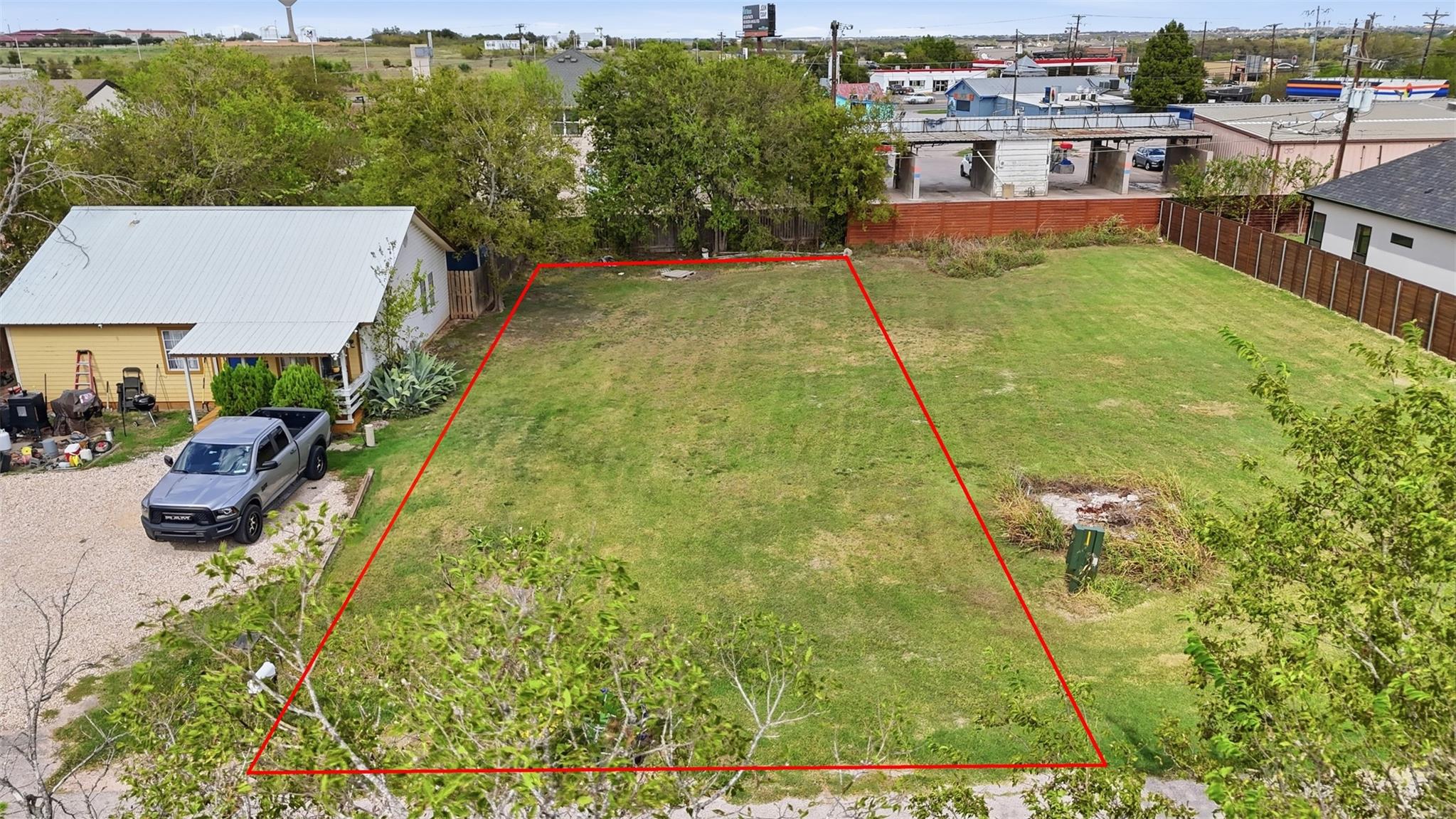 A cleared building lot outlined in red sits ready