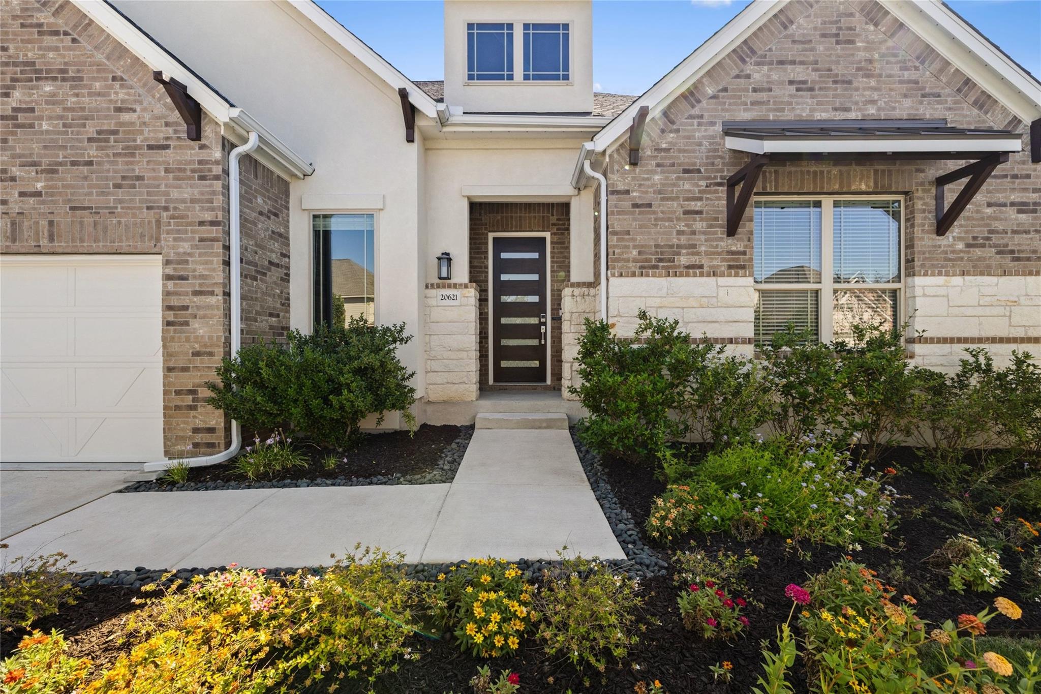 An inviting stone and brick entryway sits framed 