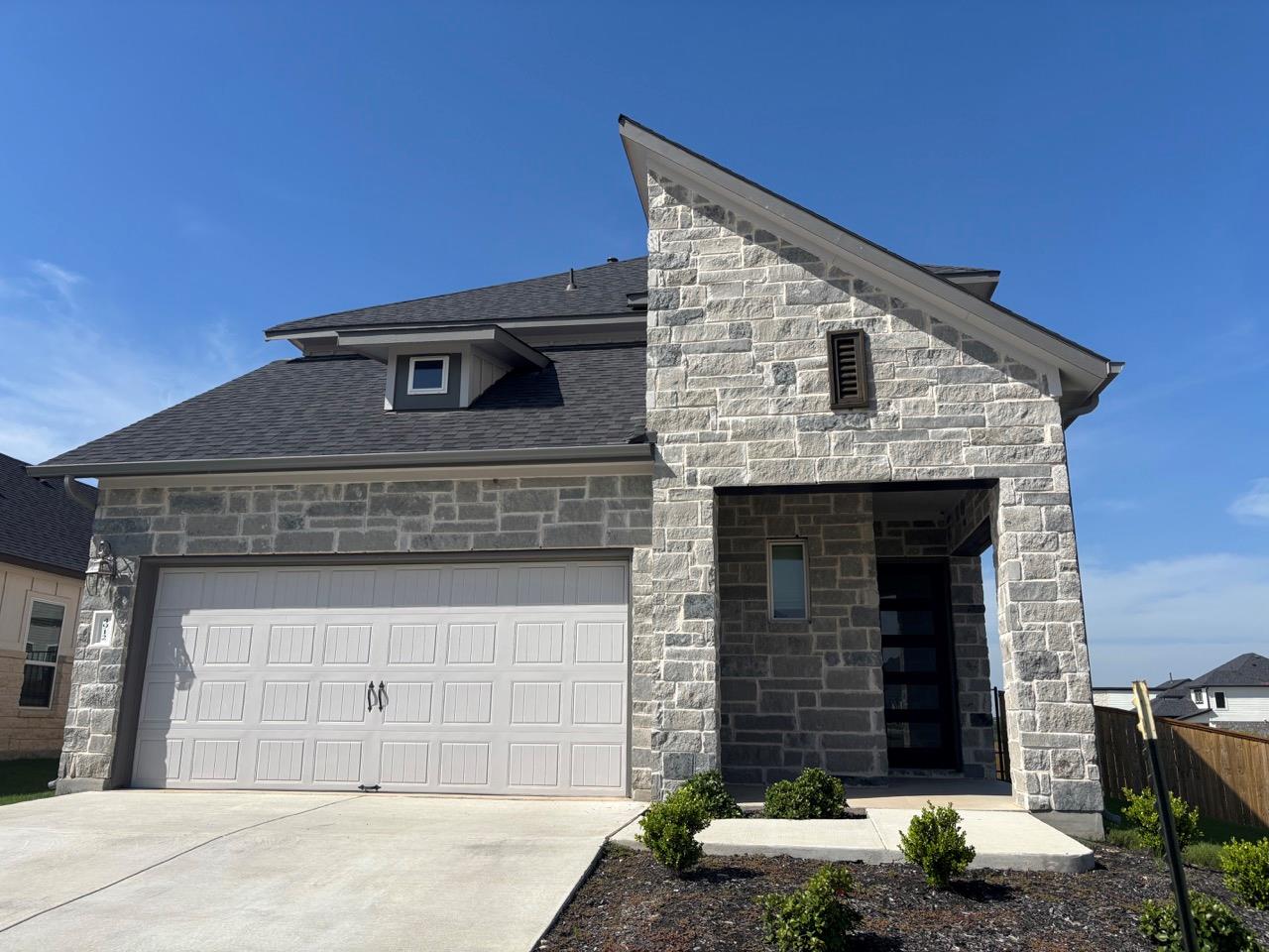 Dramatic rooflines and textured stone masonry def