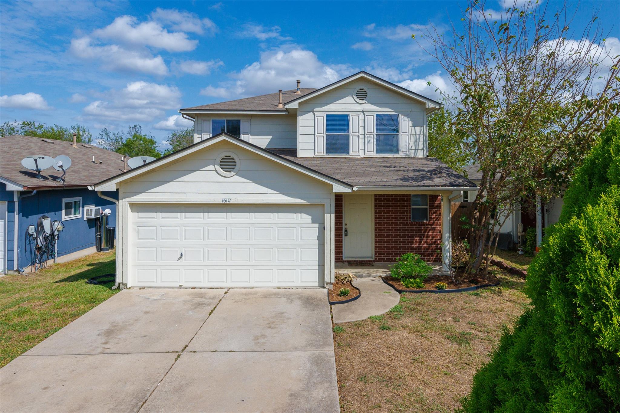 Brick and siding accents define the exterior of t