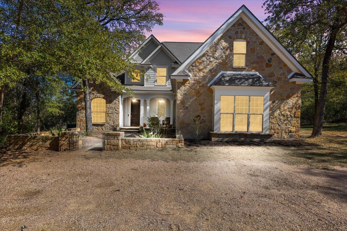 A natural stone facade pairs with gabled roofline