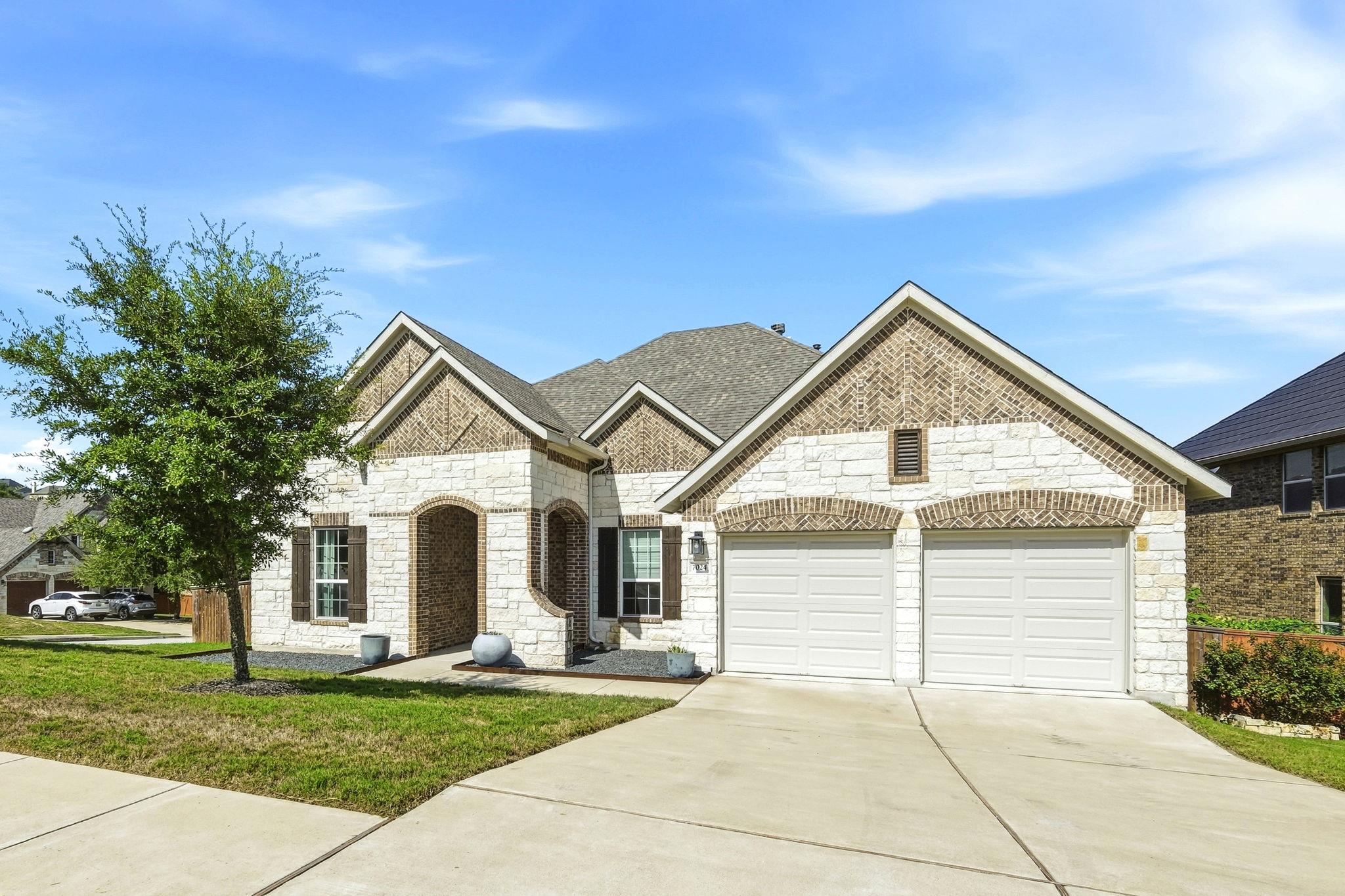 An inviting stone and brick exterior features mul