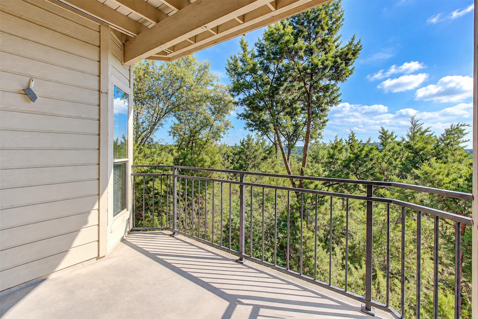 An elevated covered balcony overlooks a scenic vi