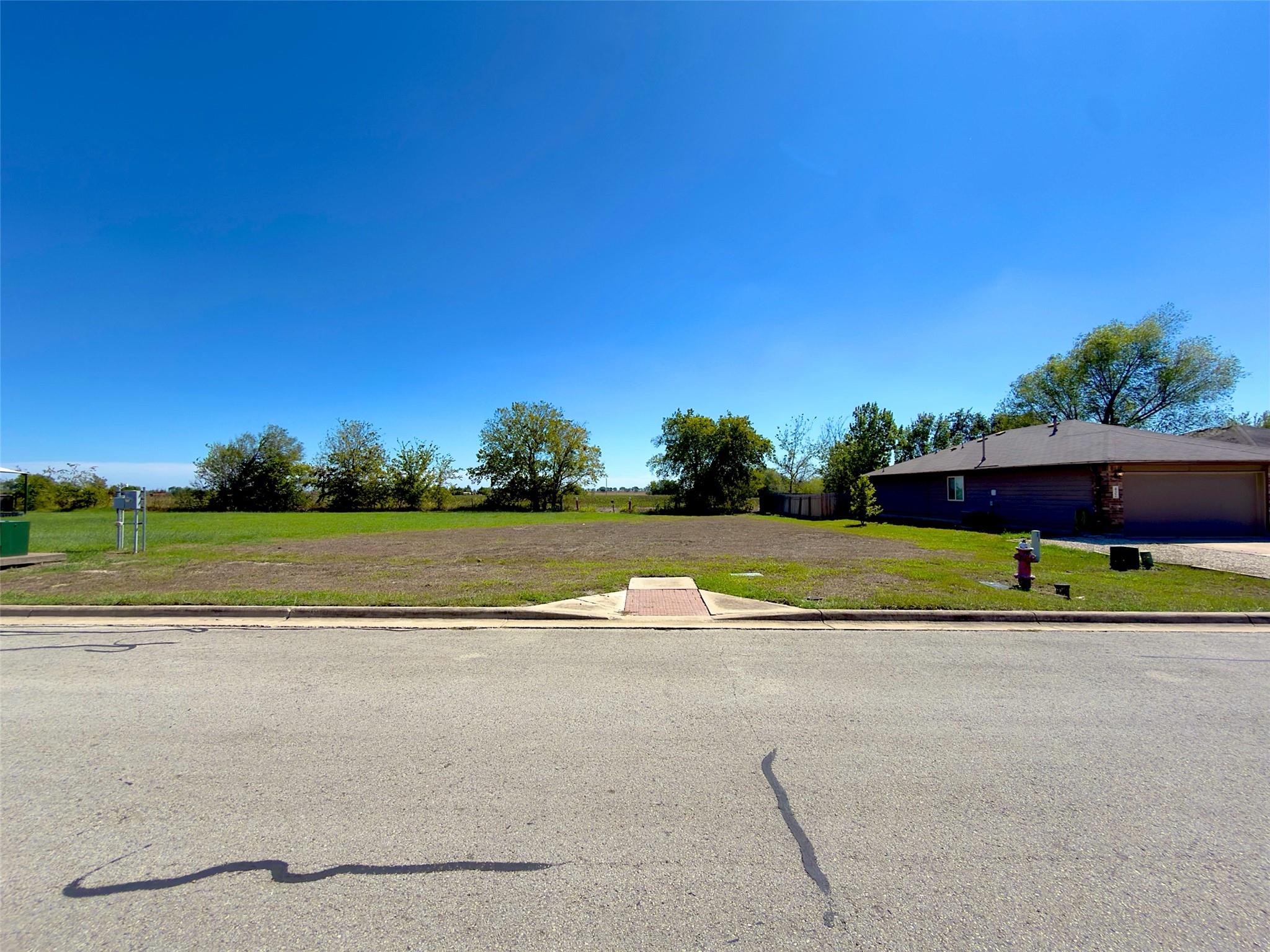 An expansive cleared building lot sits ready for 