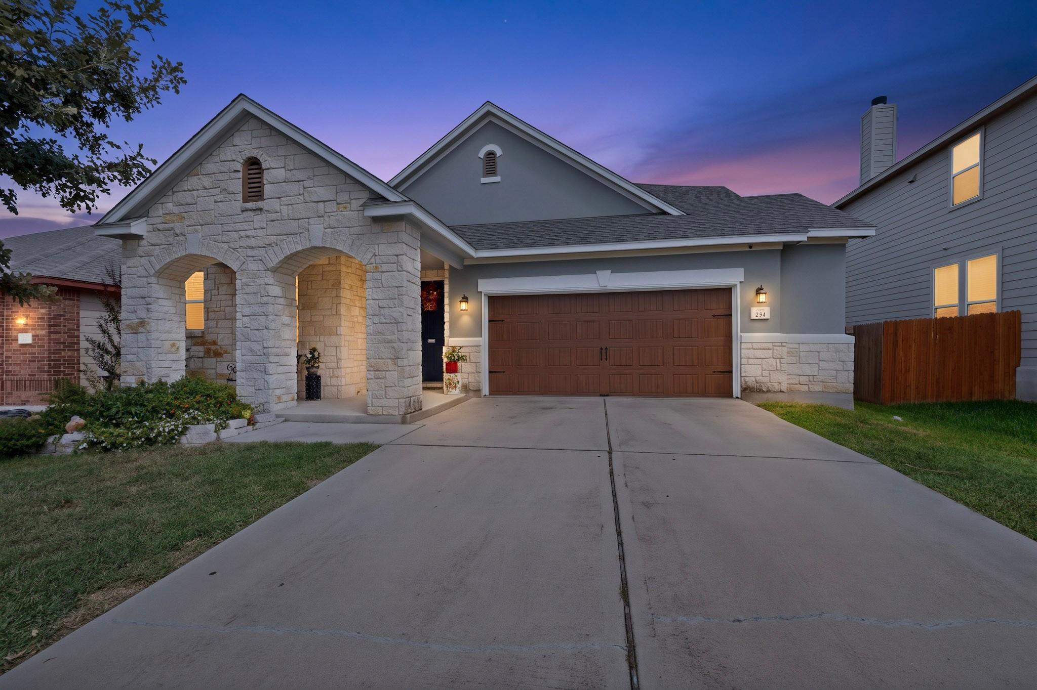 An inviting stone-accented exterior displays arch