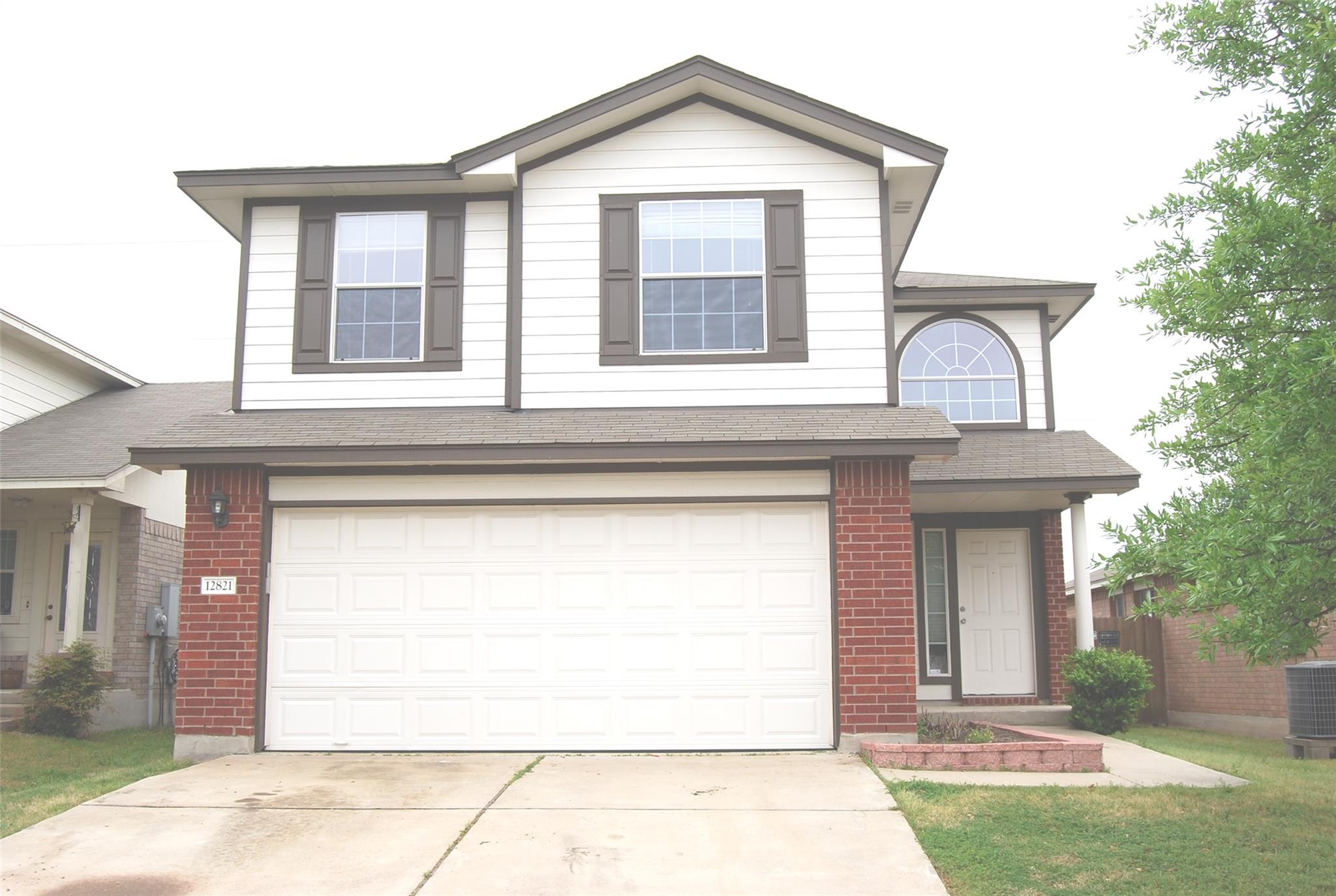 A classic brick and siding exterior features a fr