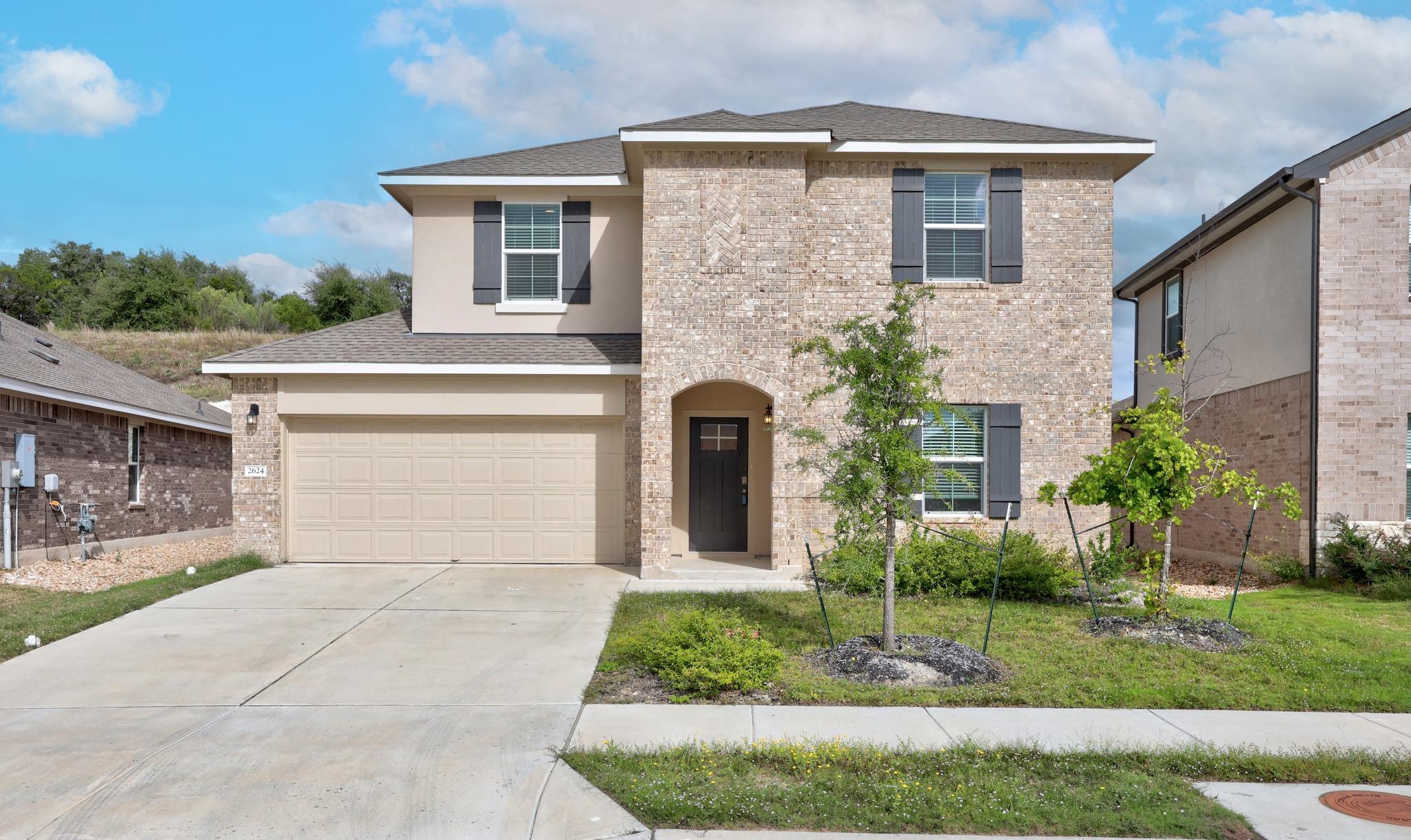 A classic brick exterior, arched entryway, and ne