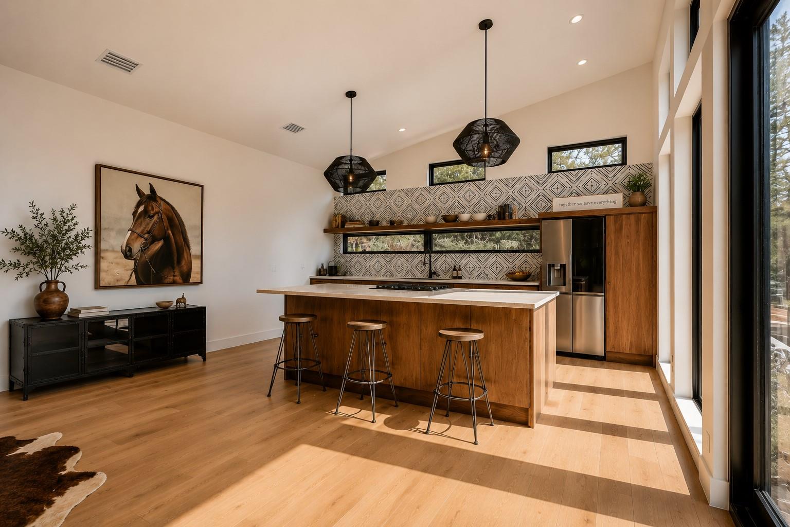 A well-lit kitchen with warm wood flooring and an