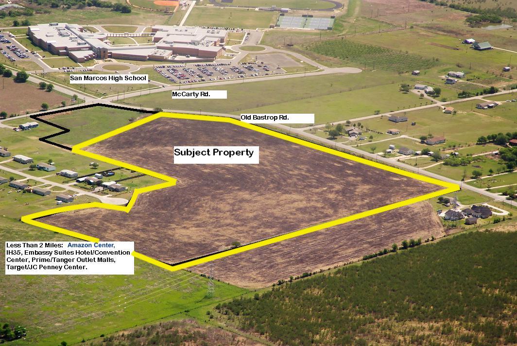 An expansive cleared acreage parcel sits position