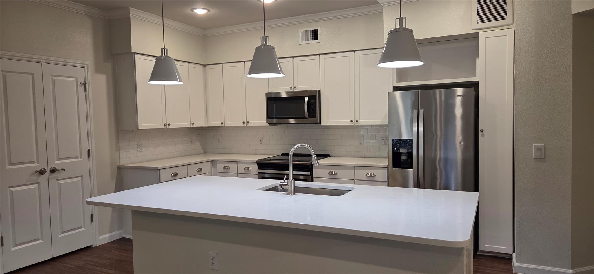 Crown molding frames white cabinetry and a spacio