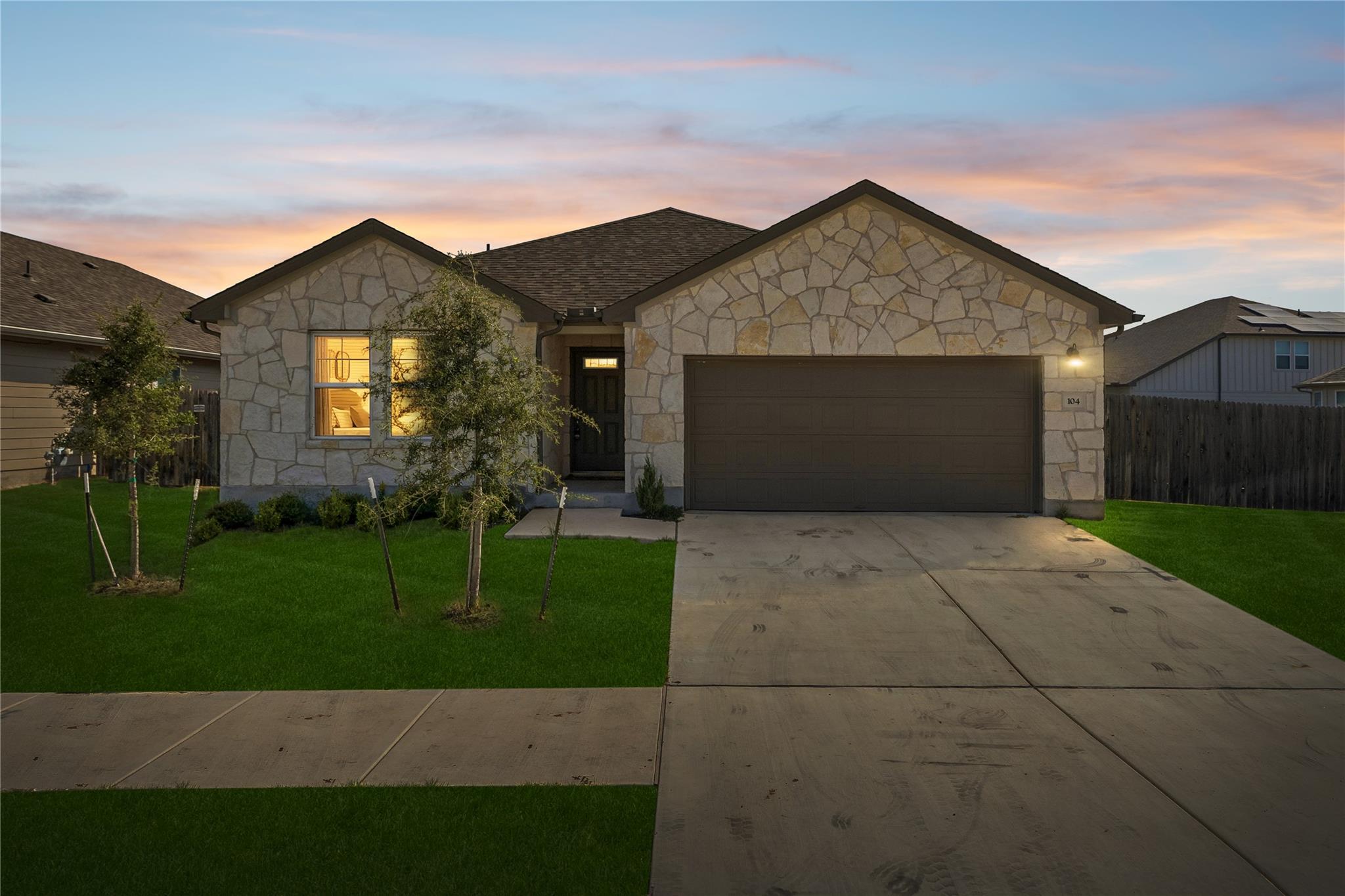 A classic stone facade and tidy lawn create an in