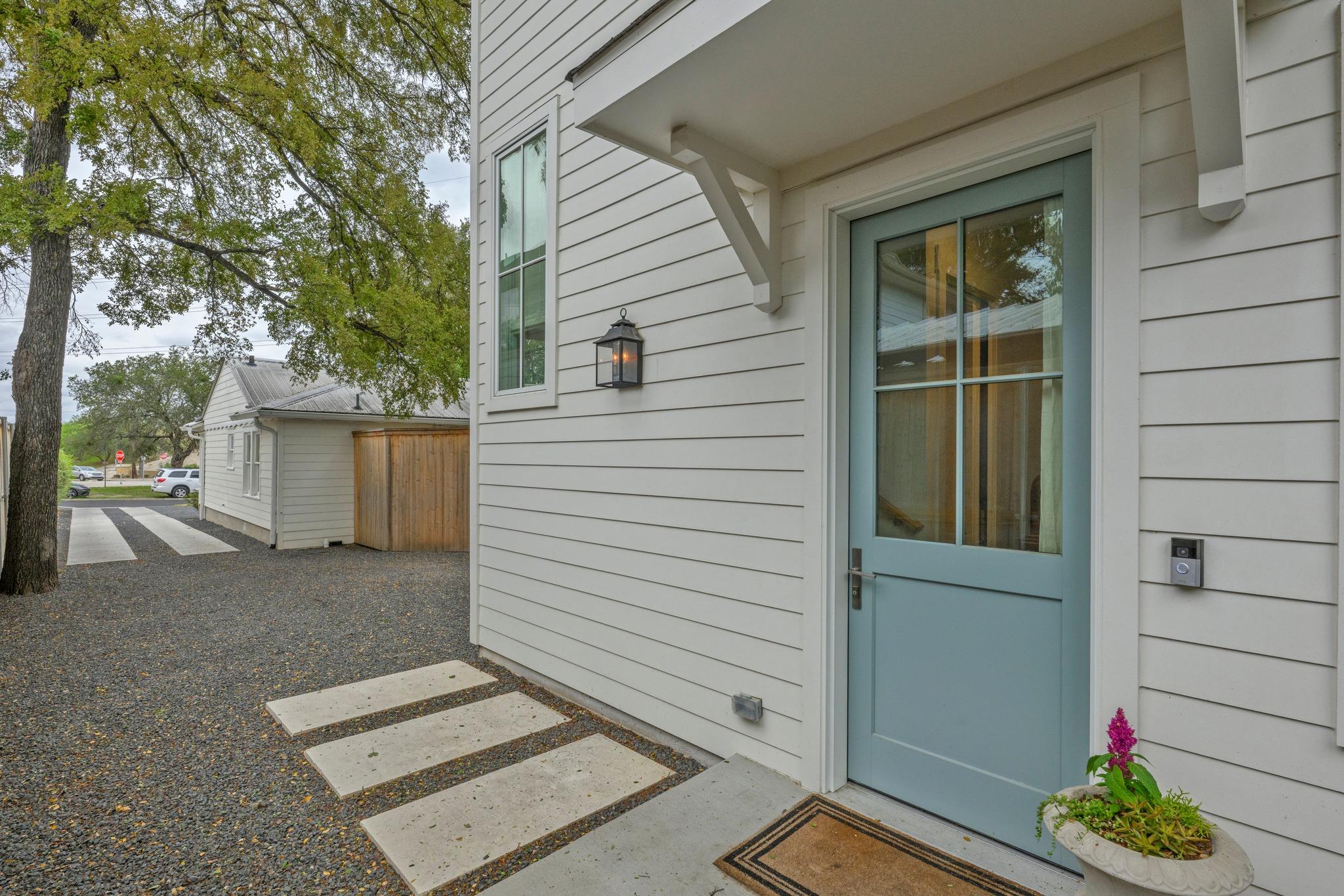 An inviting entryway presents horizontal siding, 
