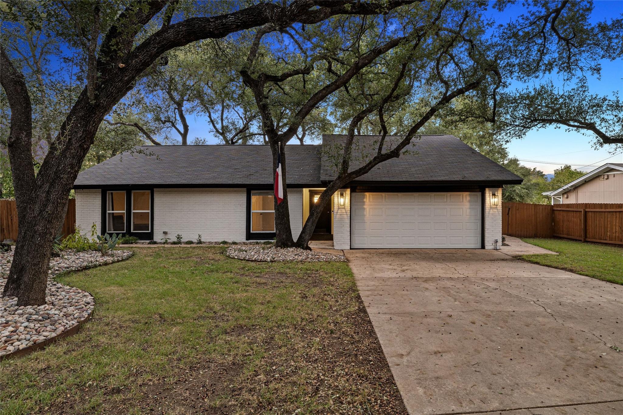 Mature trees shade a classic single-story exterio