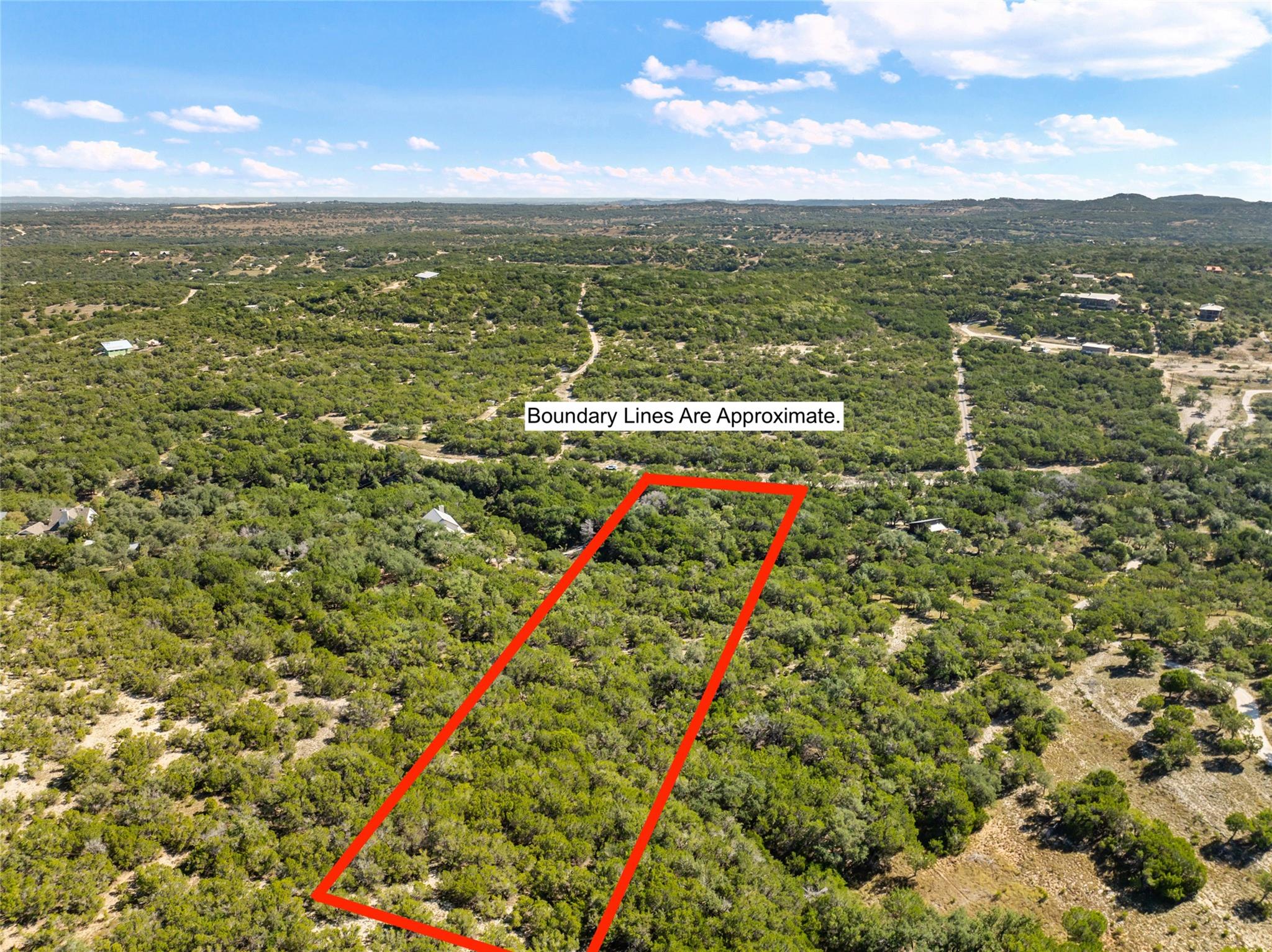 A spacious, tree-covered lot offers expansive vie