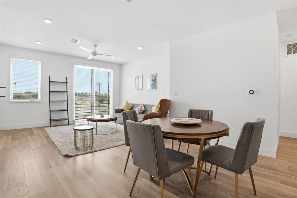 Hardwood floors and sliding glass doors define th