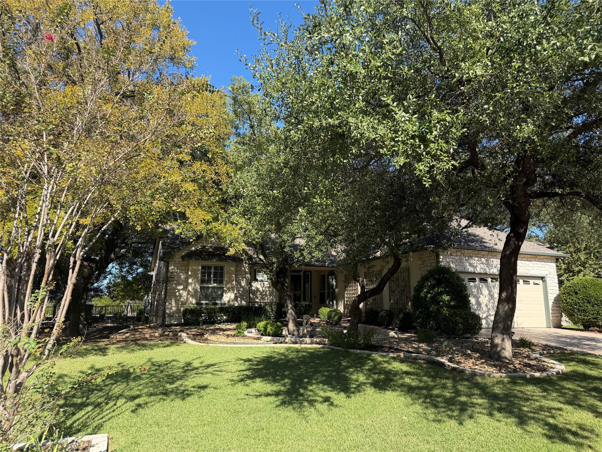 Mature trees shade a classic stone exterior with 