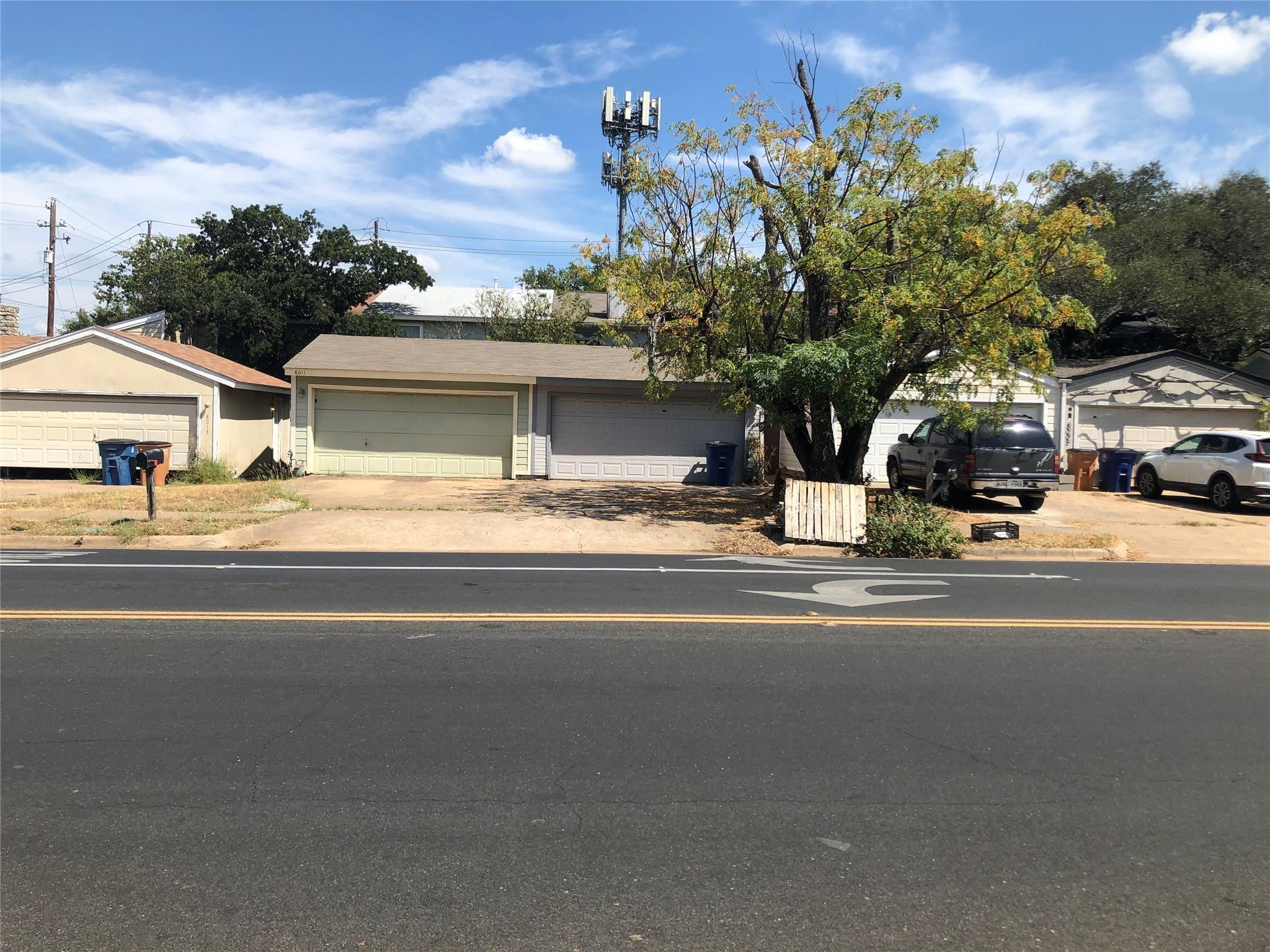 A street view of residential properties with conc