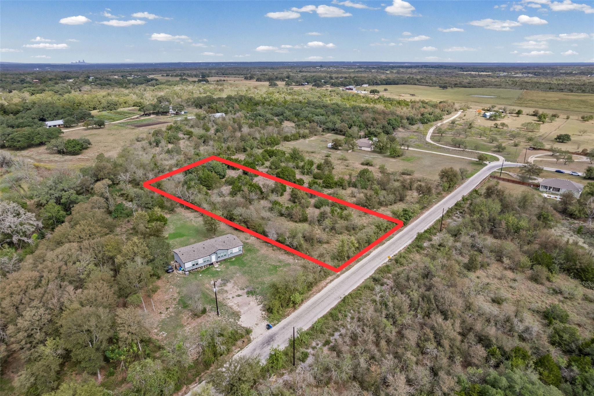 A spacious rural parcel features direct road acce