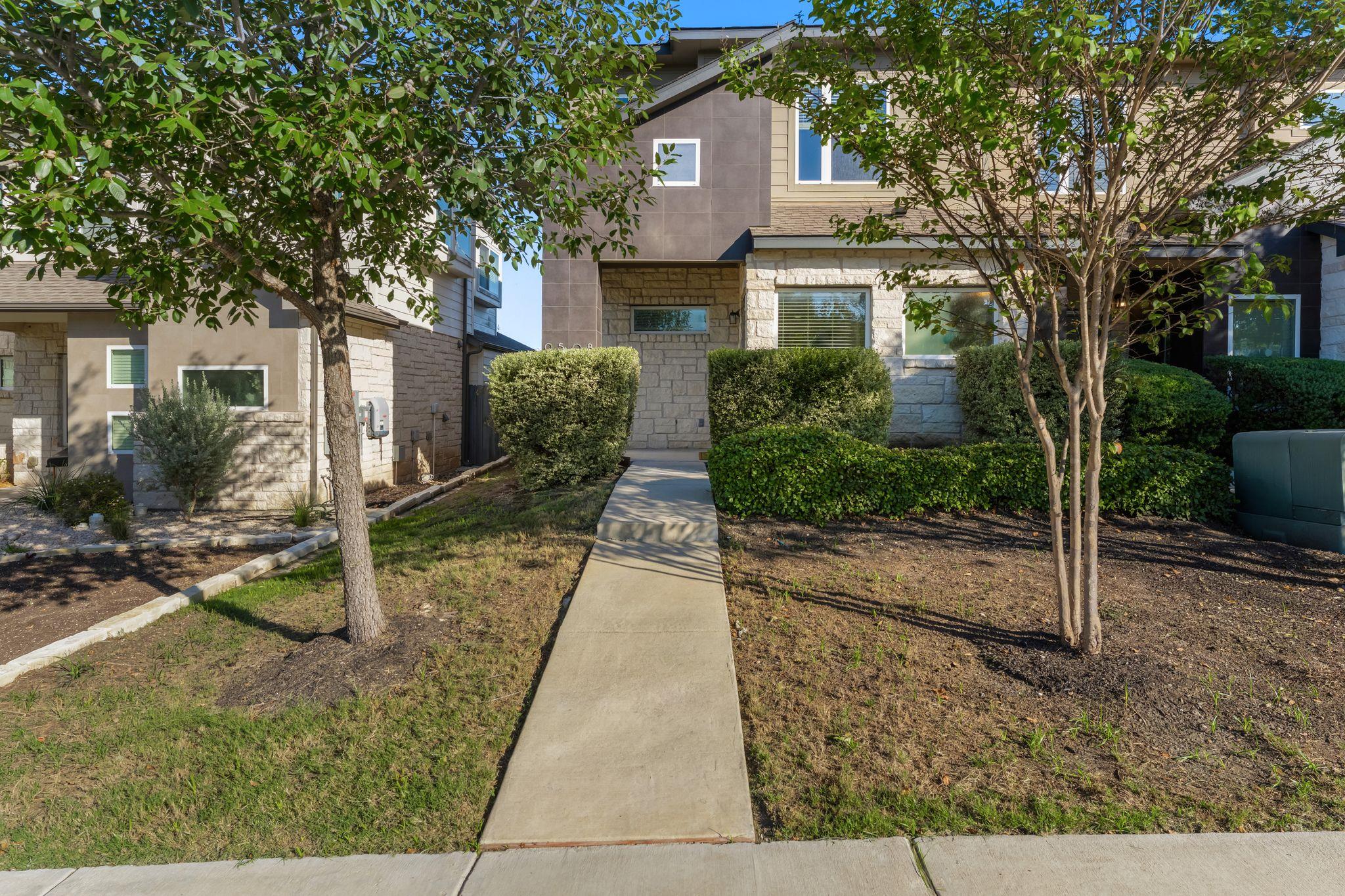 A concrete walkway leads to the private entrance 