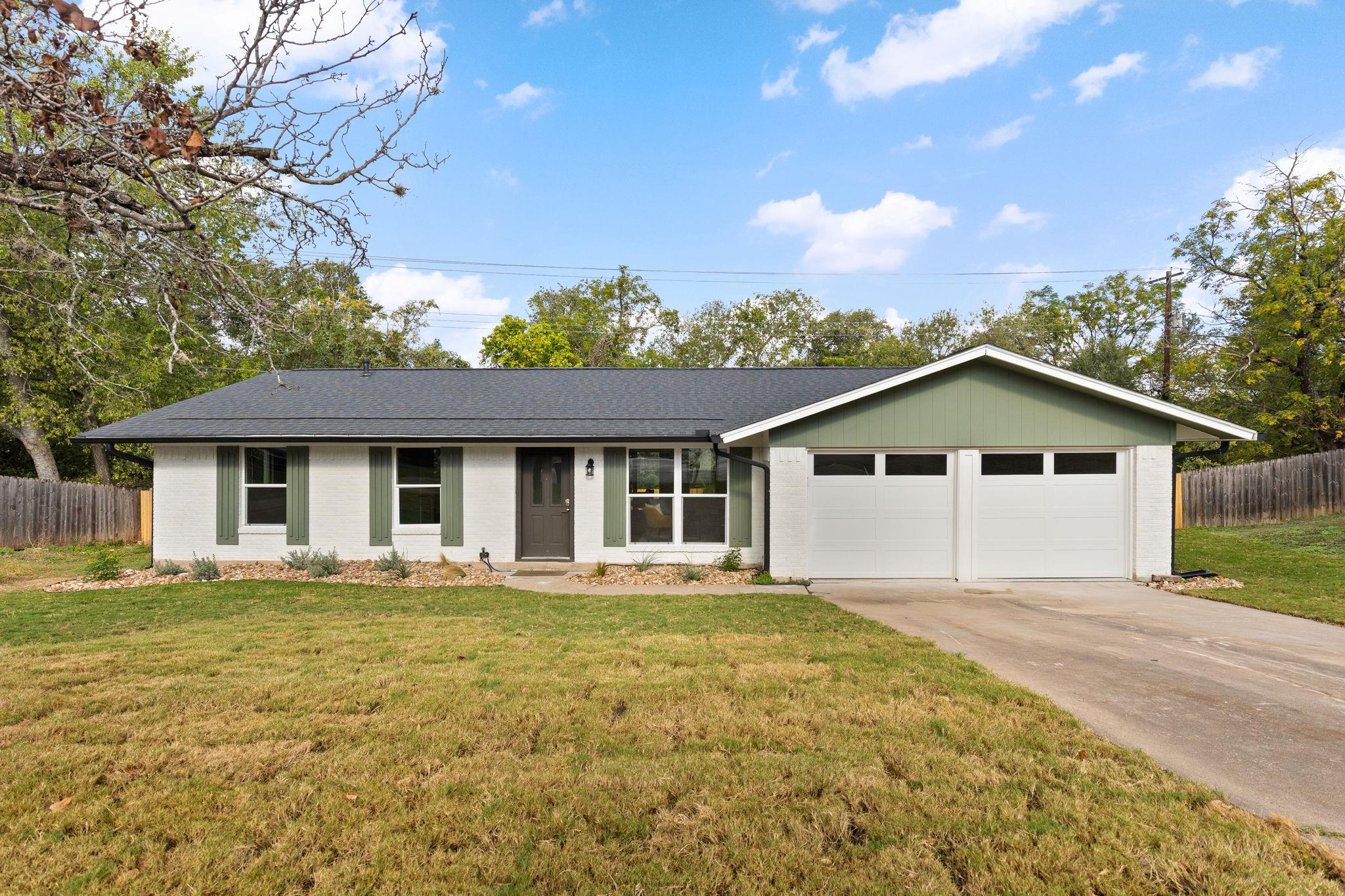 A classic ranch exterior pairs painted brick wall