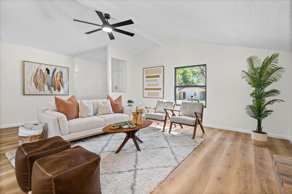 Vaulted ceilings and warm wood floors anchor this