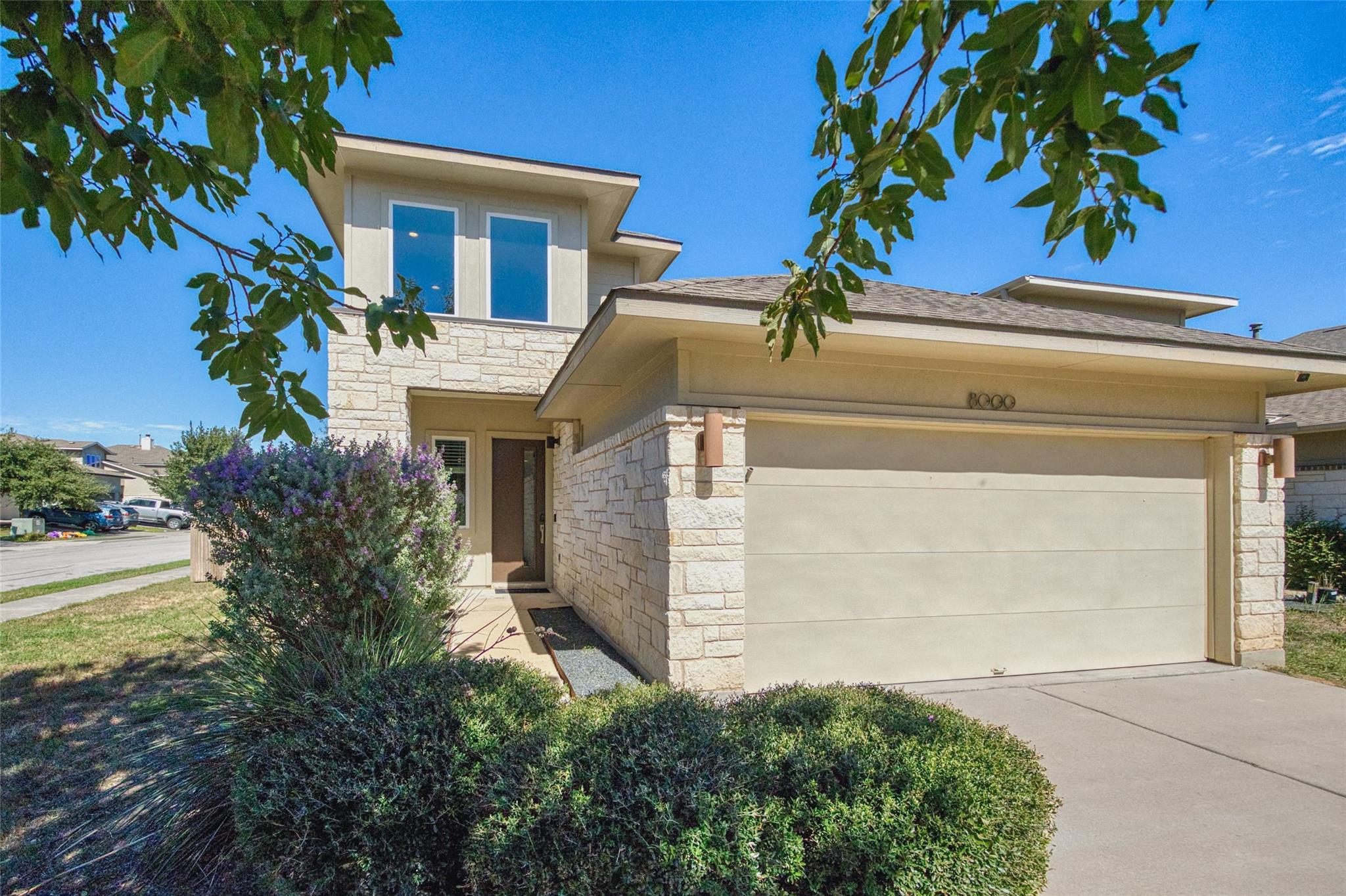 Modern stone exterior details and a spacious driv