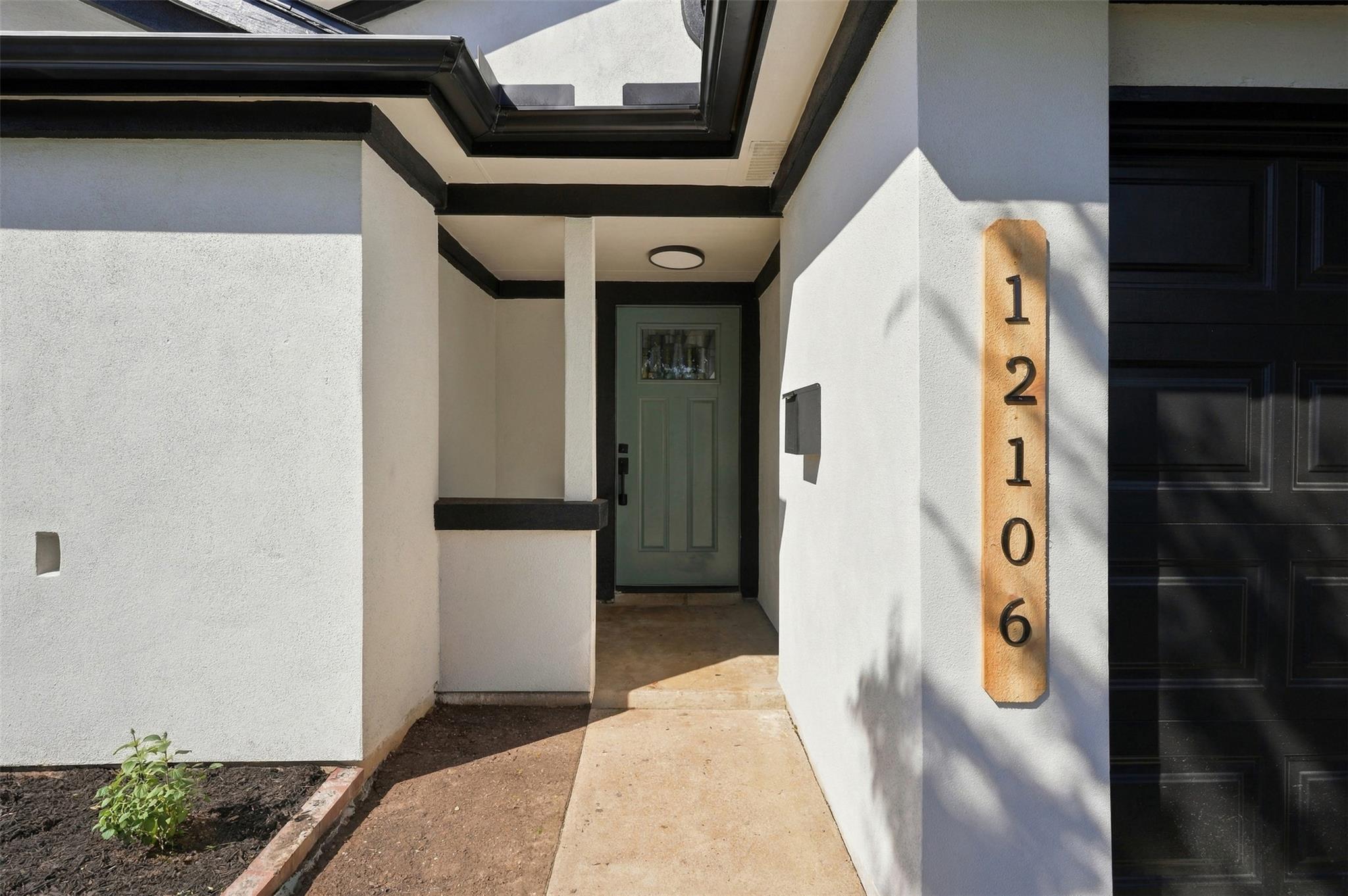 A recessed front entryway features a clean stucco