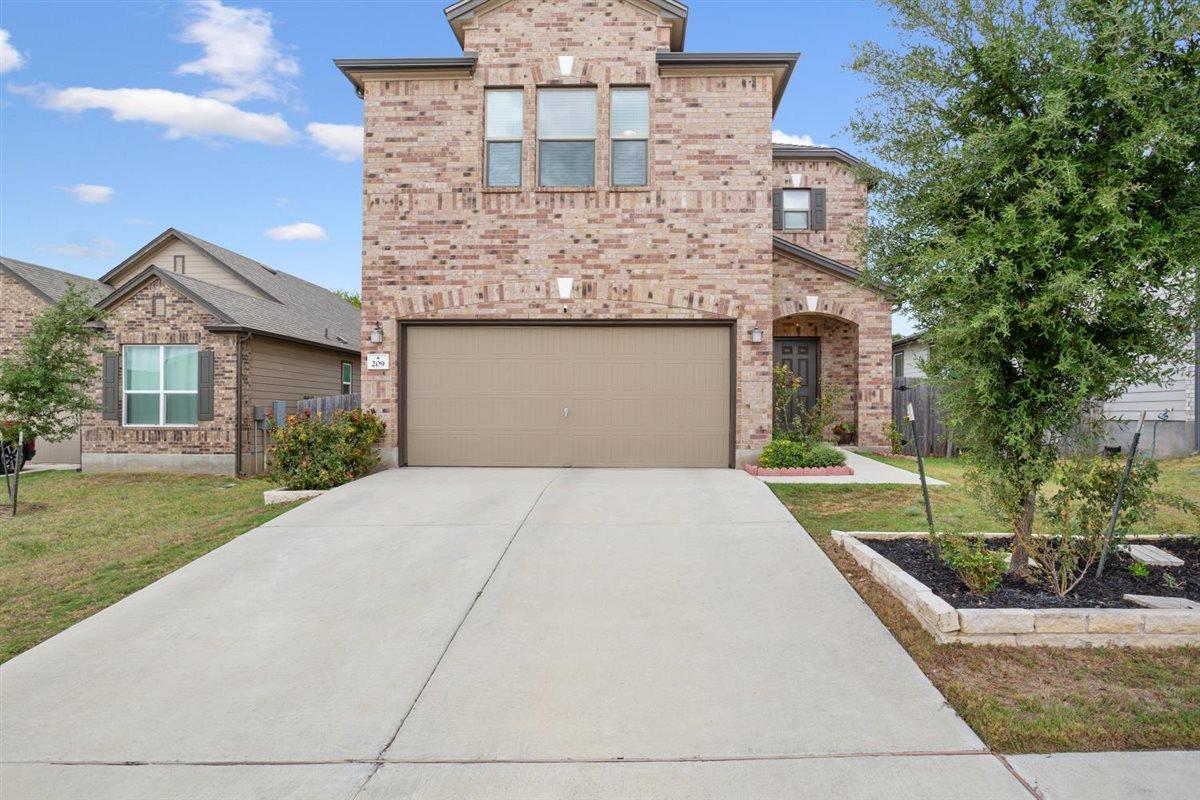 An expansive concrete driveway leads directly to 