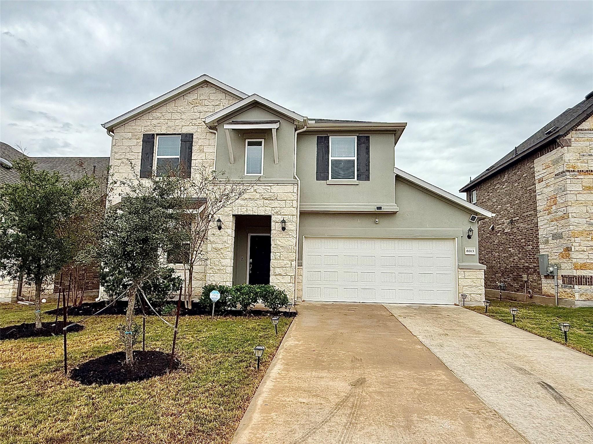 An inviting stone and stucco exterior features a 