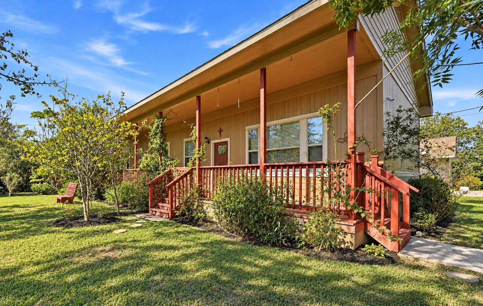 An inviting covered porch runs the length of this