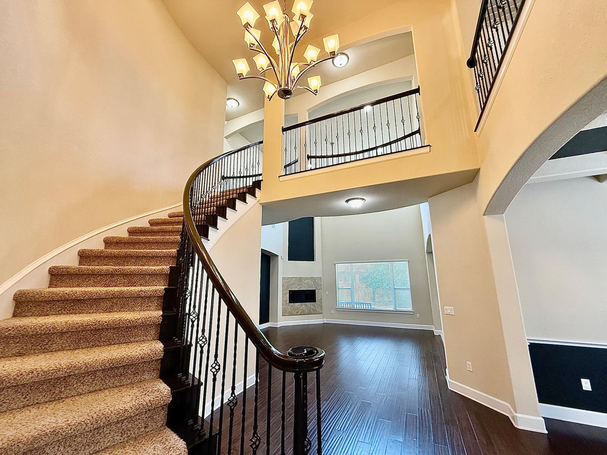 An elegant curved staircase anchors this grand fo