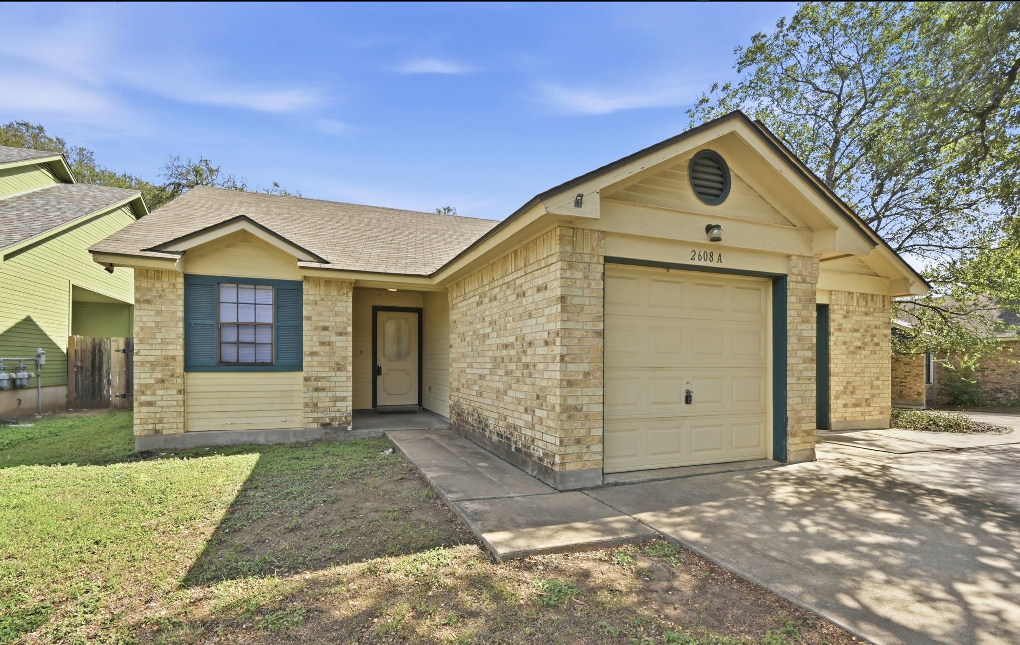 Classic brick accents and a dedicated garage defi