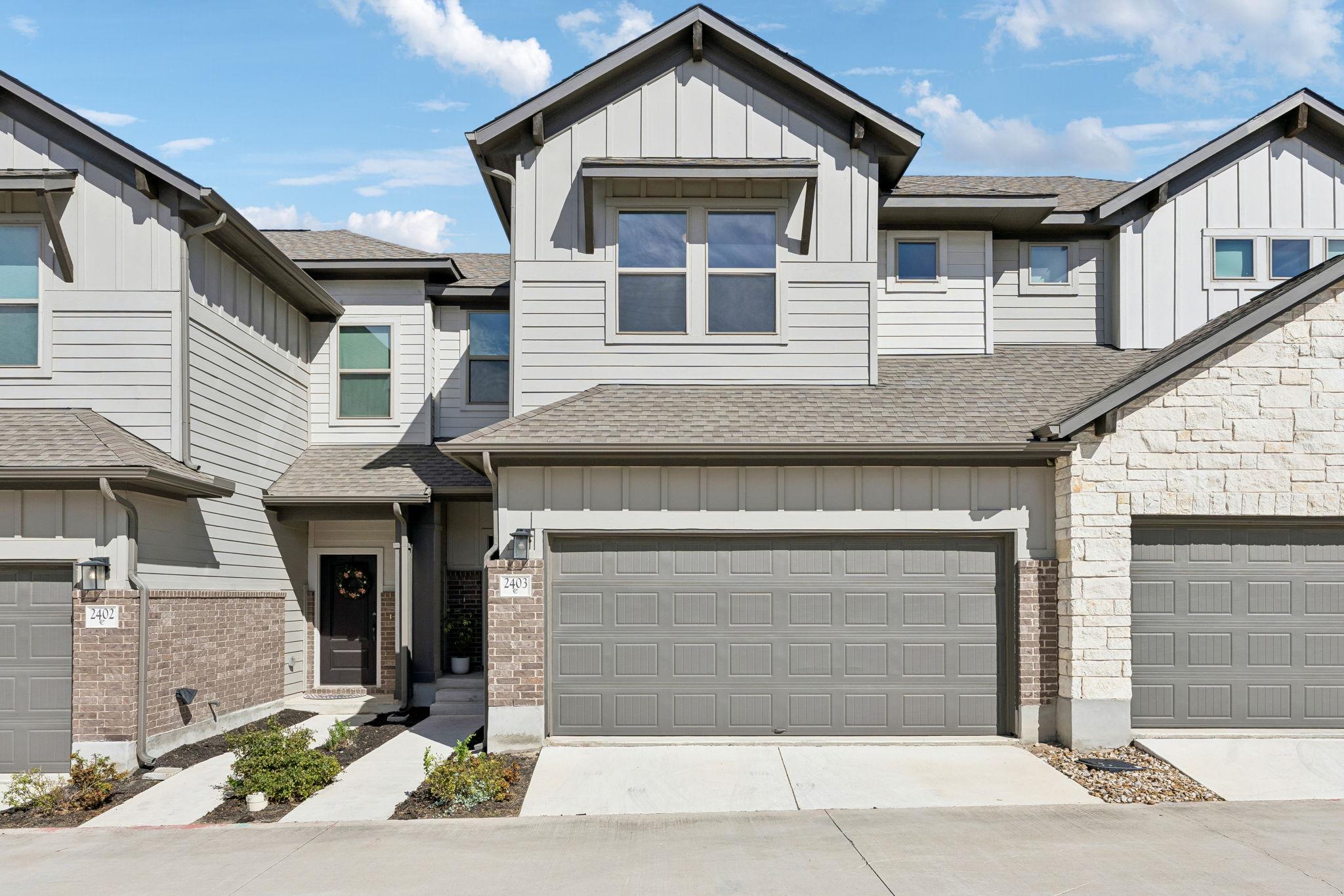 Multi-textured siding, brick accents, and a stone